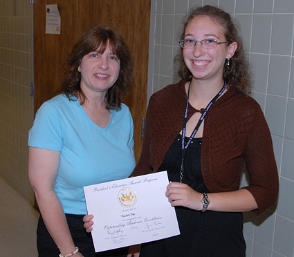 Deb stands with Rachel, as she displays her certificate for the math award.